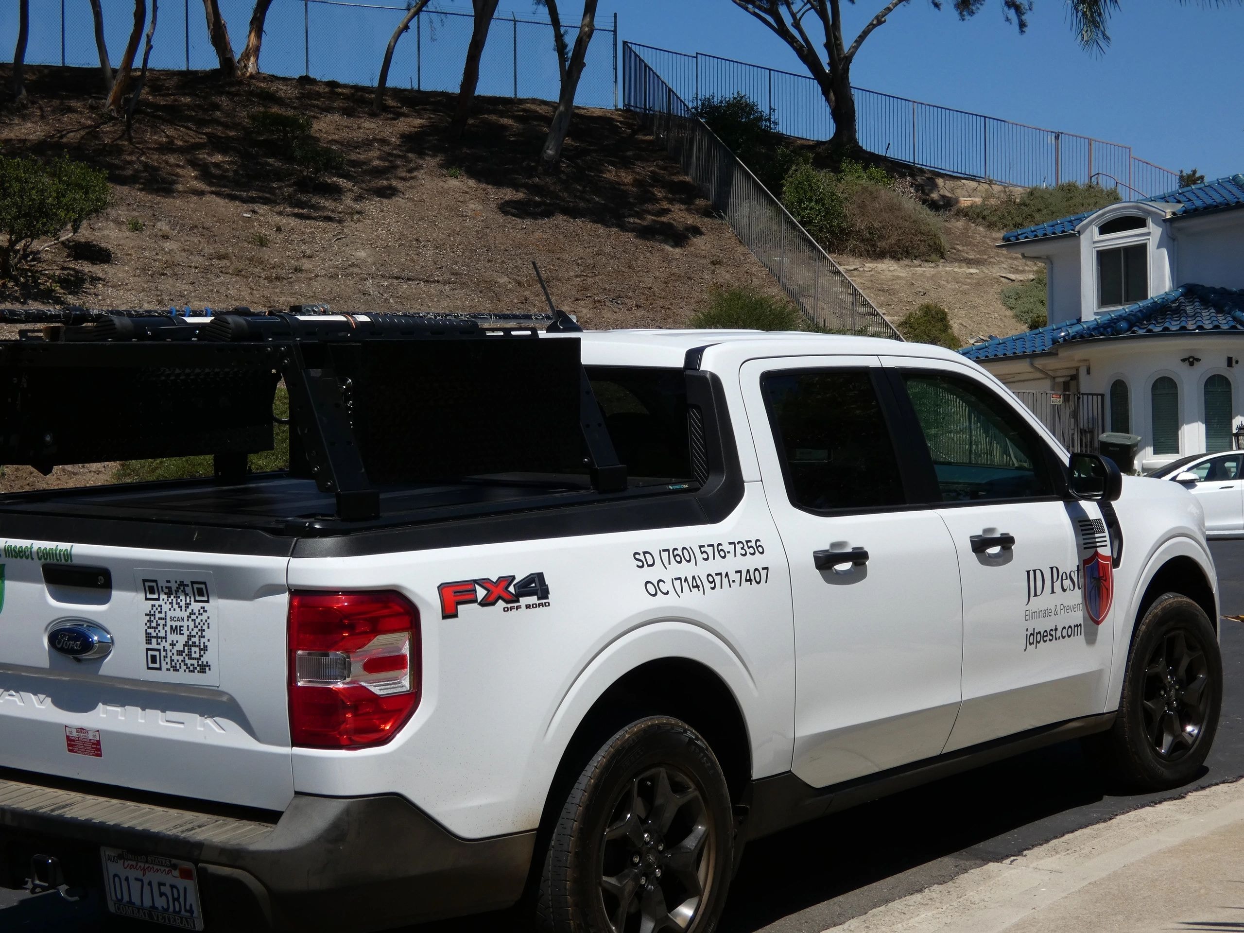 JD Pest technician working at a residential property